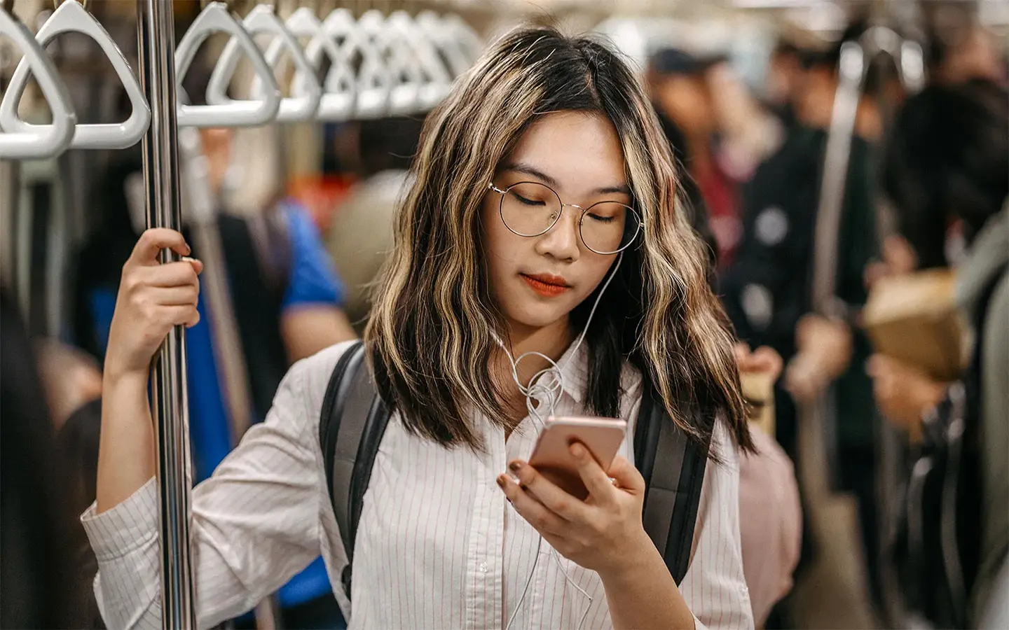 Young person Gen Z using smartphone in mrt.
